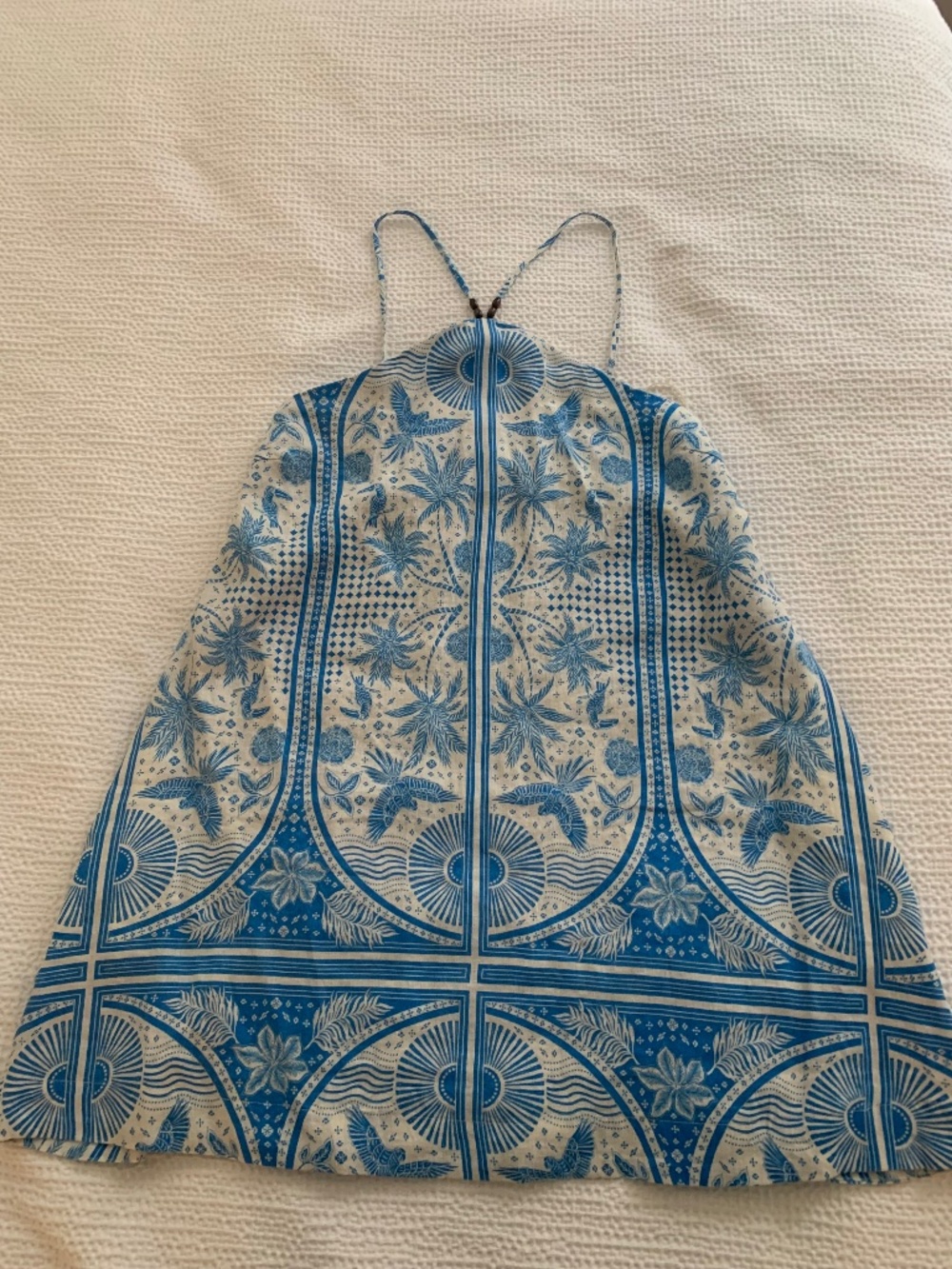 Blue macaw mini dress with pockets and beaded straps.